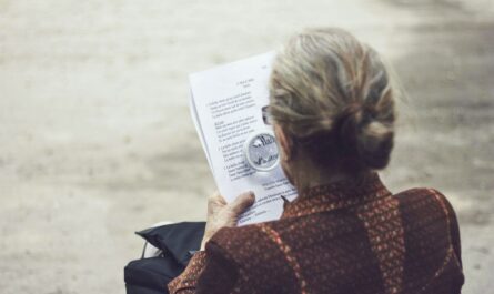 woman in brown top reading paper