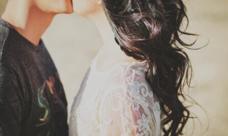 man kissing woman